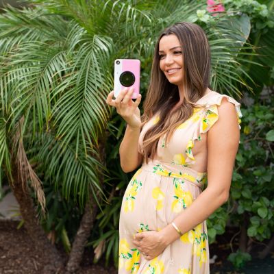 pregnant woman holding a camera